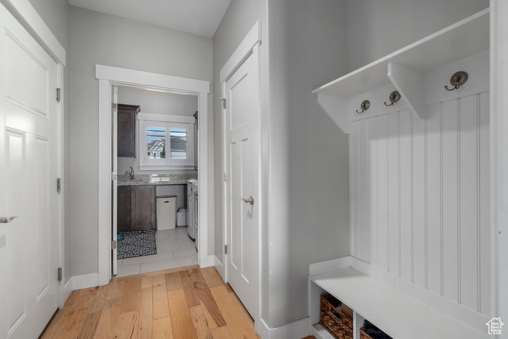 Mudroom featuring light hardwood / wood-style flooring and sink