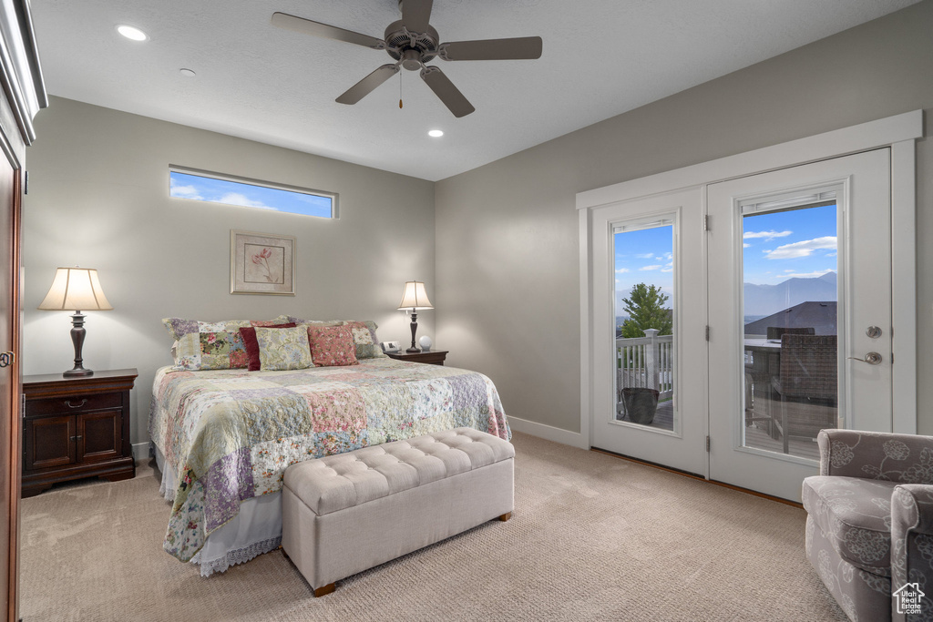 Carpeted bedroom featuring access to outside, french doors, and ceiling fan