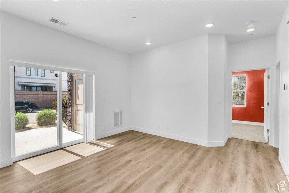 Empty room with light hardwood / wood-style floors