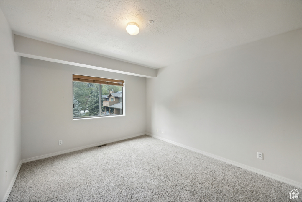 Empty room featuring carpet floors