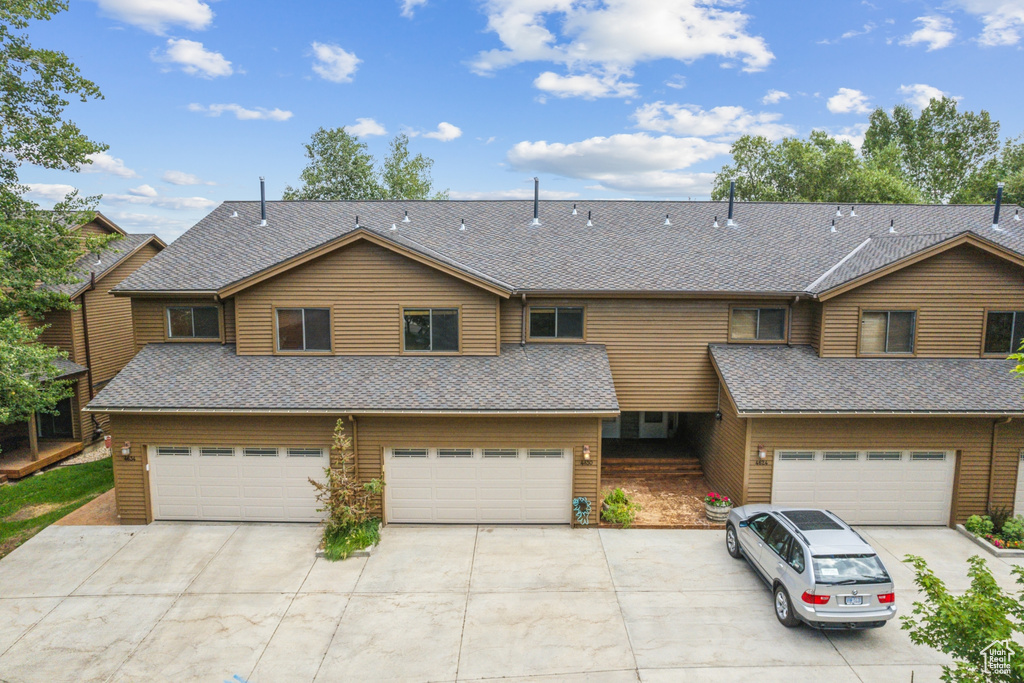 View of front facade featuring a garage