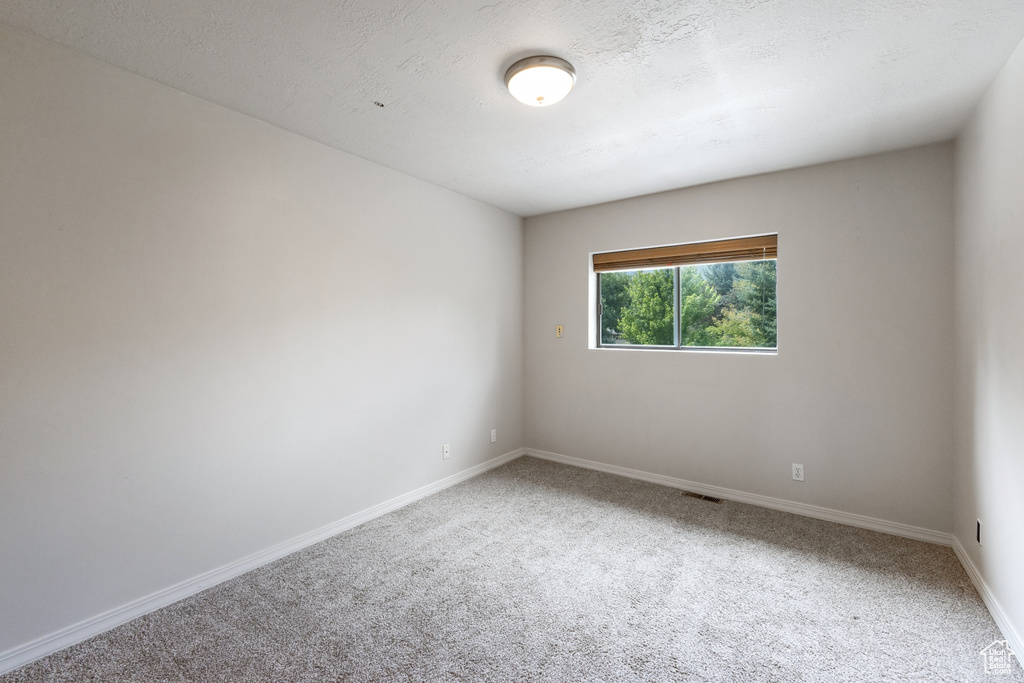 Unfurnished room featuring carpet flooring