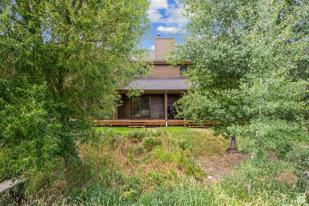 Back of house featuring a wooden deck