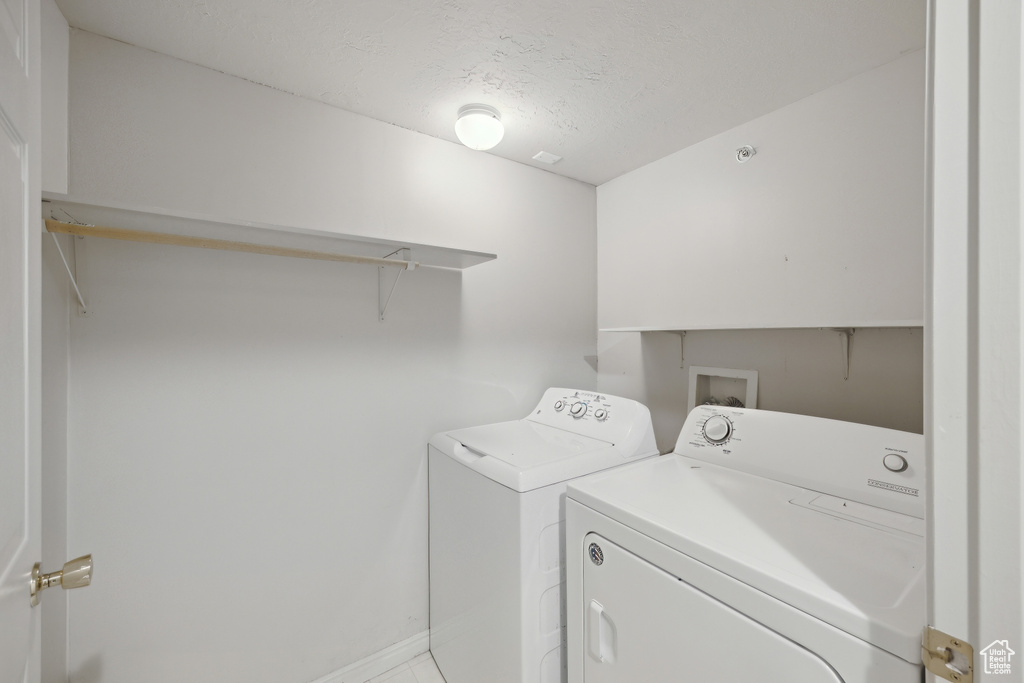 Clothes washing area featuring separate washer and dryer