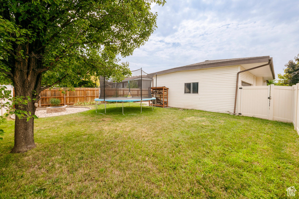 View of yard with a trampoline