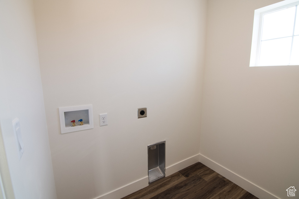 Laundry room featuring electric dryer hookup, hookup for a washing machine, and dark hardwood / wood-style floors