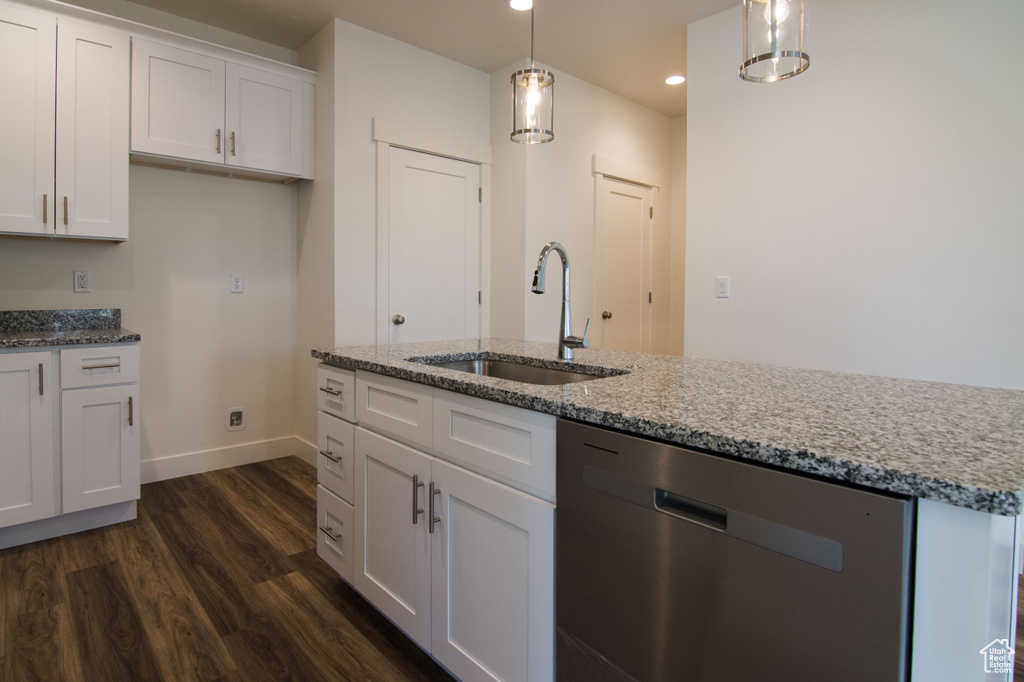 Kitchen with light stone counters, white cabinets, dark wood-type flooring, dishwasher, and sink