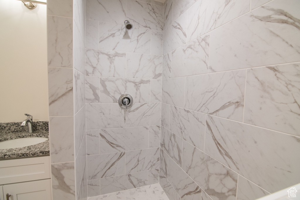 Bathroom featuring vanity and a tile shower