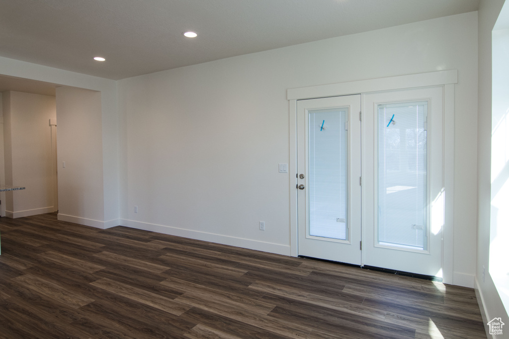 Interior space with plenty of natural light and dark wood-type flooring