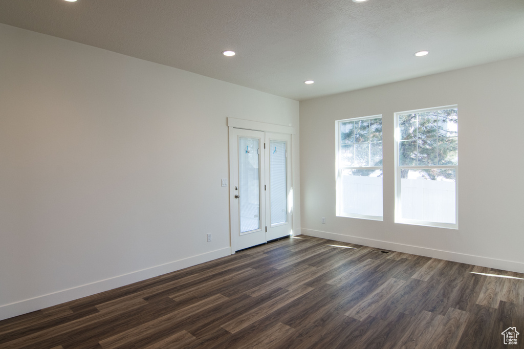 Empty room with dark hardwood / wood-style floors