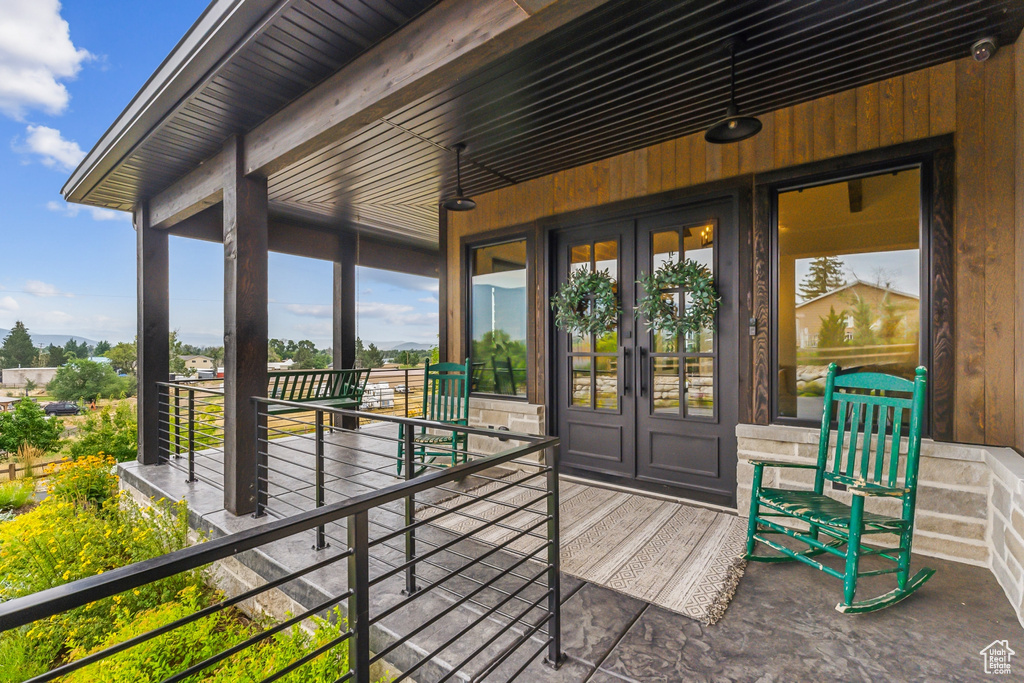 Wooden terrace featuring french doors