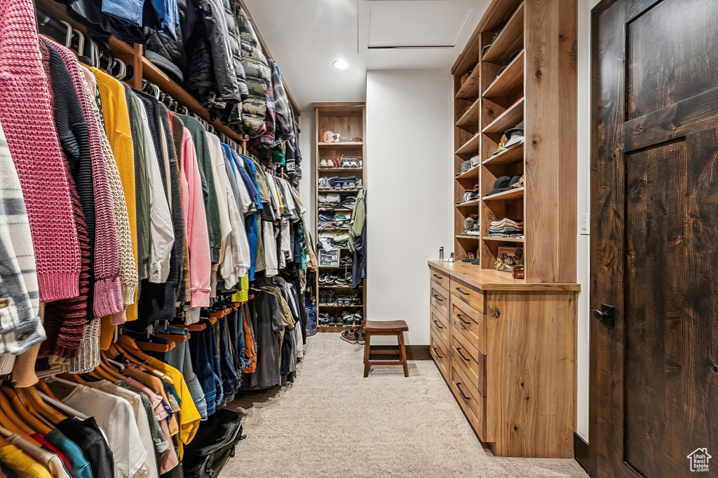 Walk in closet featuring light carpet