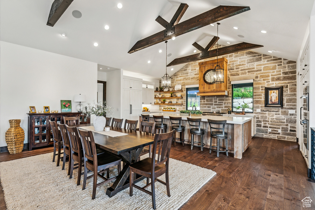 Dining room featuring sink, a notable chandelier, dark hardwood / wood-style flooring, and high vaulted ceiling