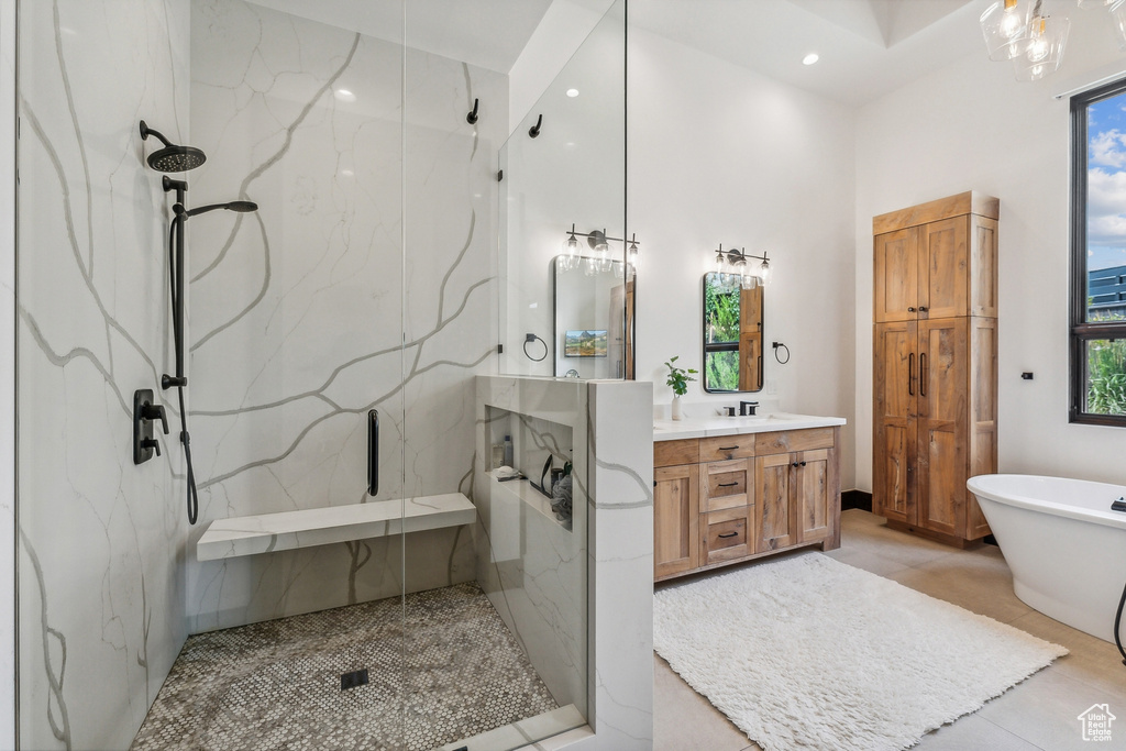 Bathroom with shower with separate bathtub, tile patterned floors, vanity, and a wealth of natural light