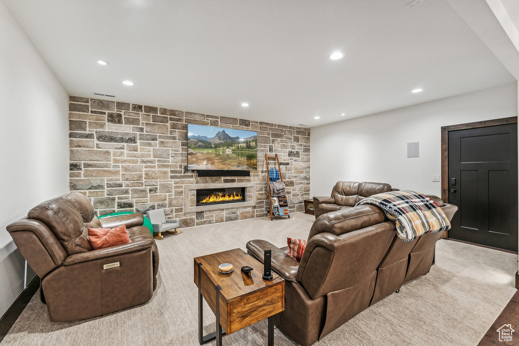 Carpeted living room featuring a fireplace