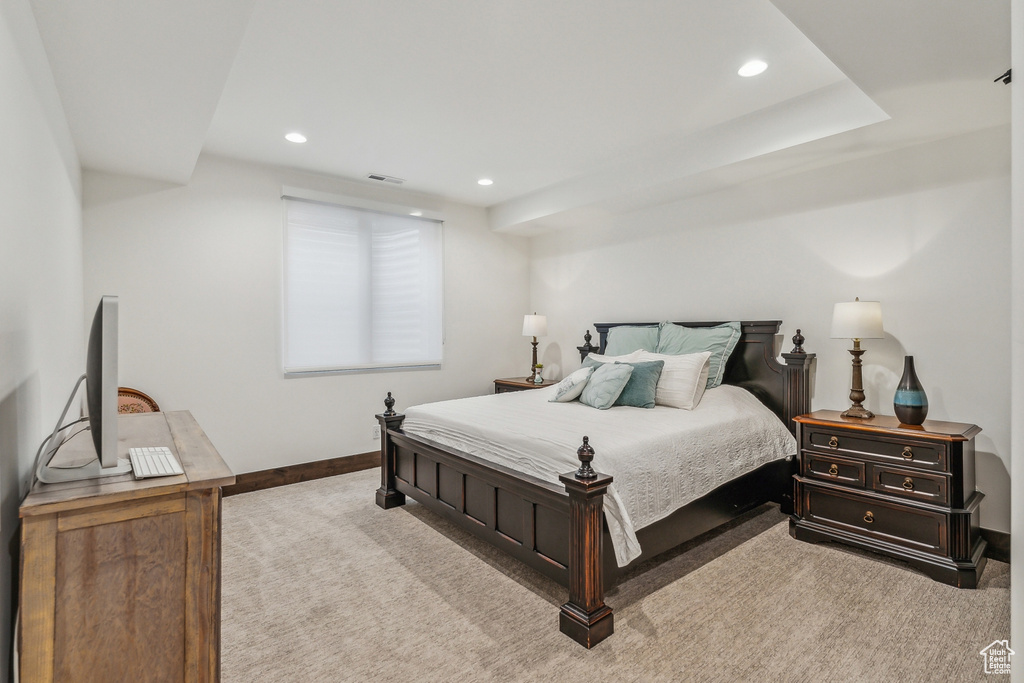 Bedroom featuring light carpet