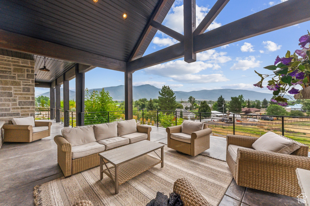 View of patio with a balcony, a mountain view, and an outdoor living space