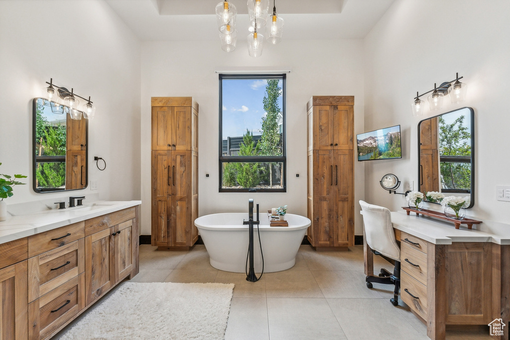 Bathroom with plenty of natural light, vanity, and tile patterned floors