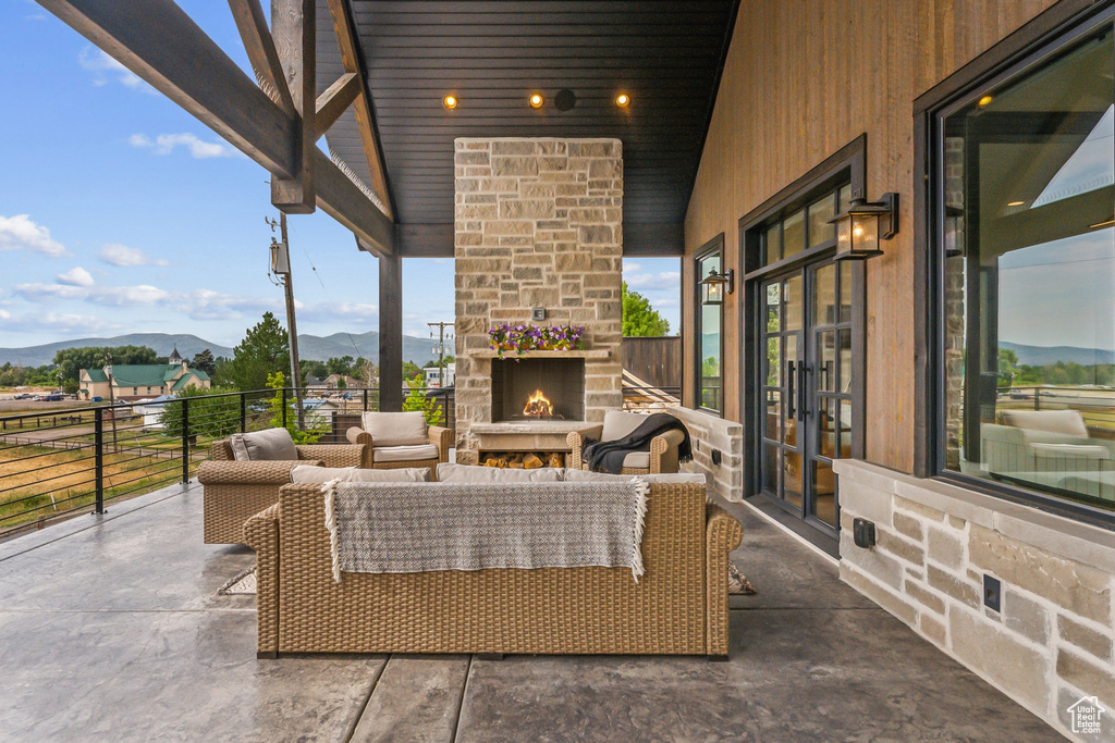 View of patio / terrace featuring an outdoor living space with a fireplace and a mountain view