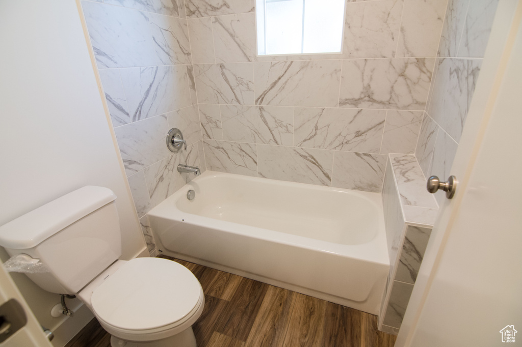 Bathroom with wood-type flooring and toilet