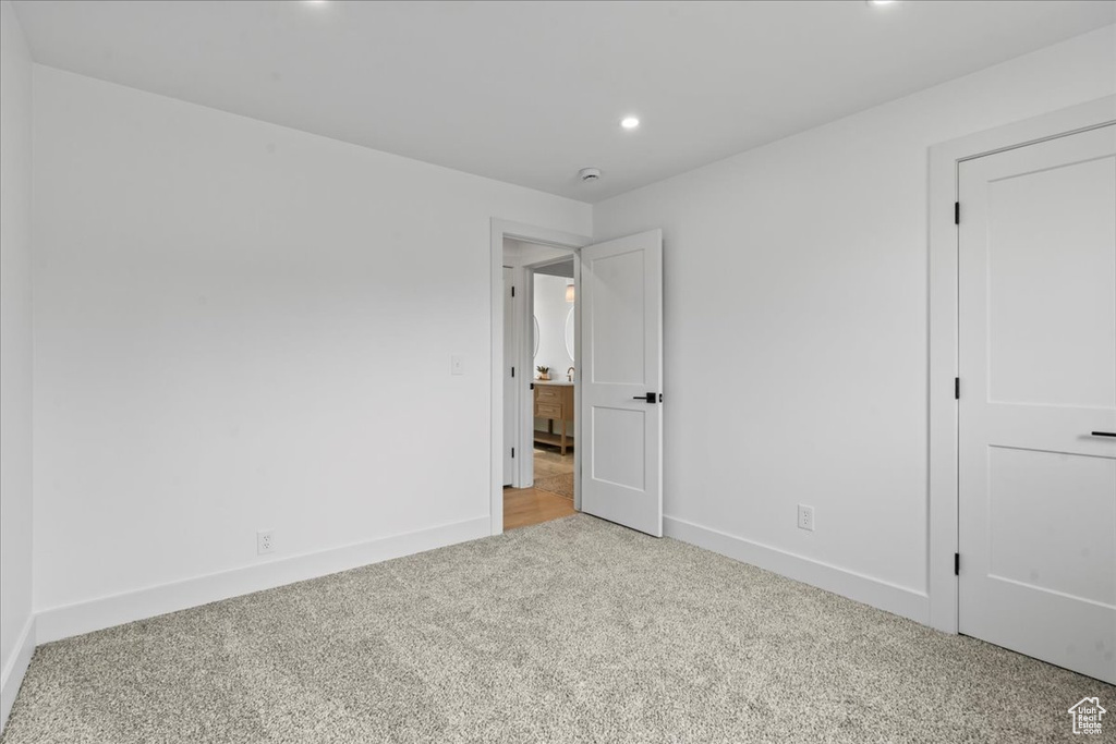 Unfurnished bedroom featuring light carpet