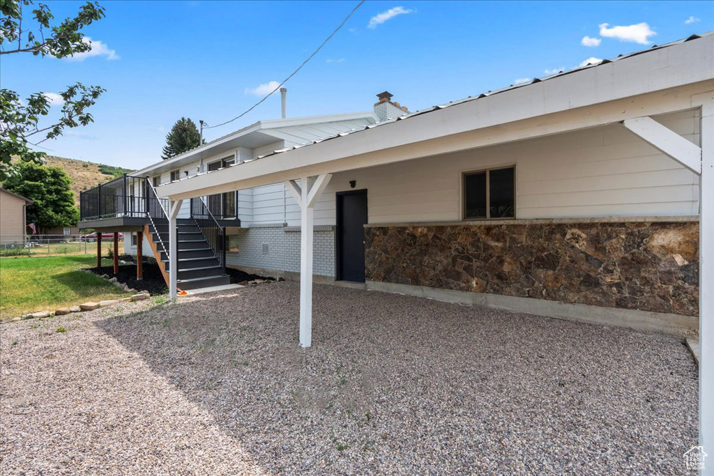 Rear view of house featuring a wooden deck