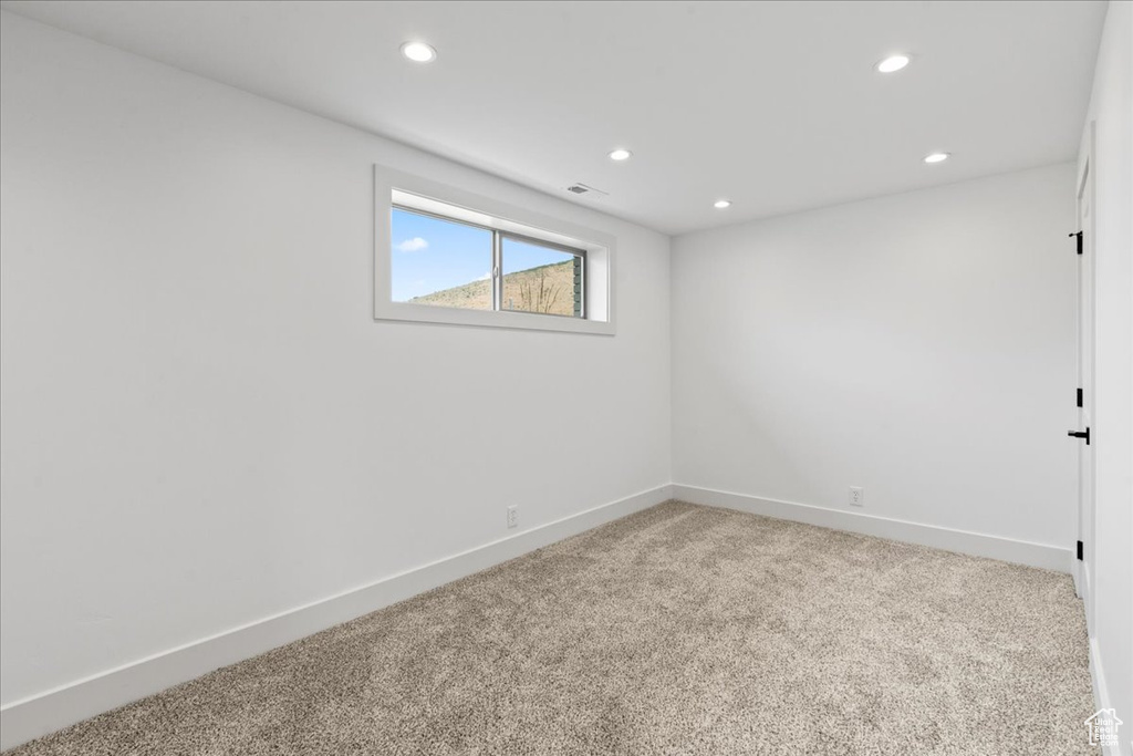 Spare room featuring light colored carpet