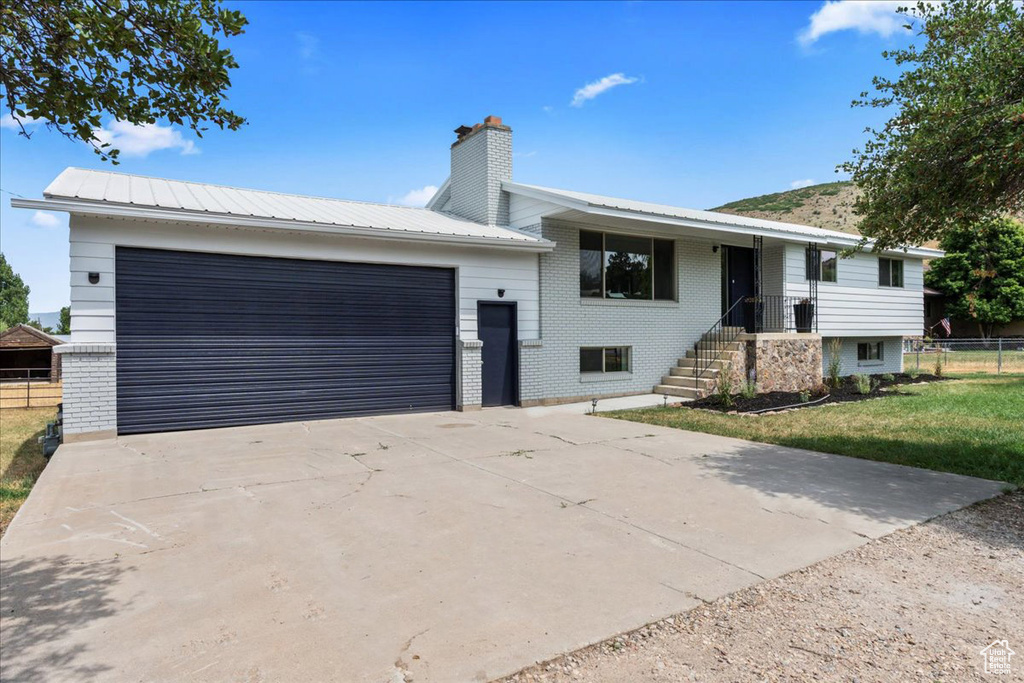 View of front of home with a garage and a front yard