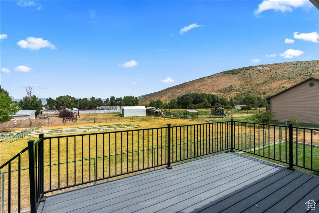 Wooden deck with a lawn and a mountain view