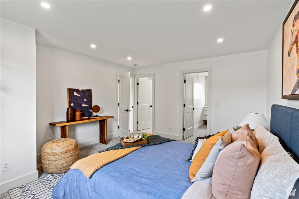 Bedroom featuring light carpet