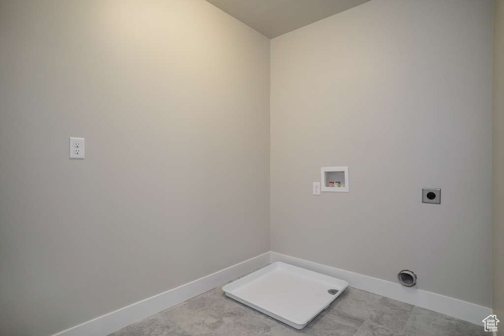 Laundry room featuring hookup for a washing machine, light tile patterned flooring, and hookup for an electric dryer