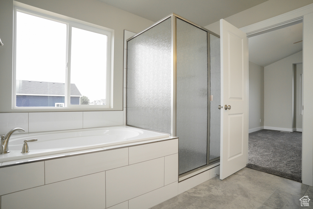 Bathroom with separate shower and tub and tile patterned flooring