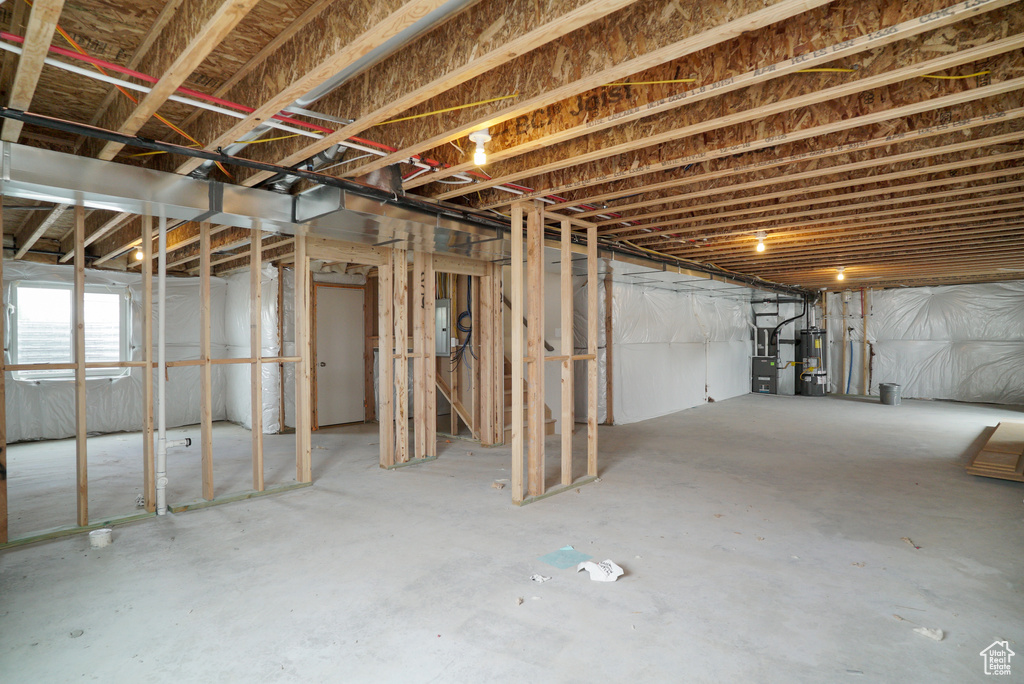 Basement with gas water heater and electric panel