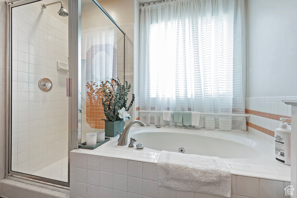 Bathroom with plus walk in shower and a wealth of natural light