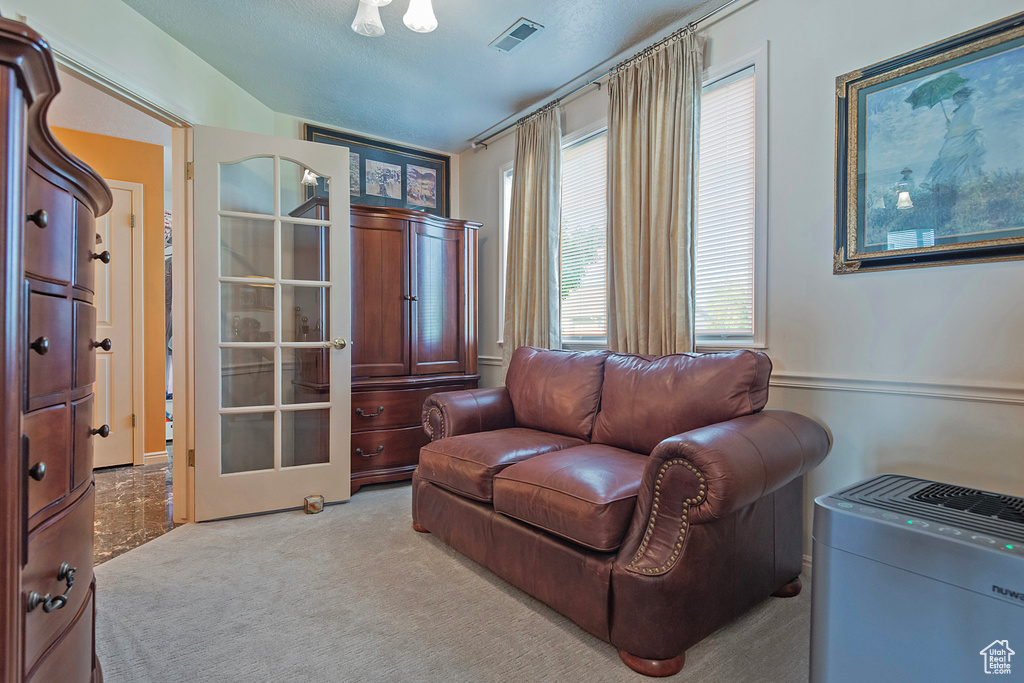 Sitting room featuring light colored carpet