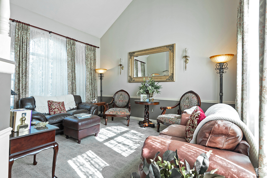 Living room featuring high vaulted ceiling and light colored carpet