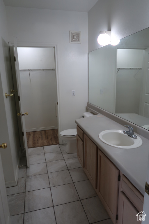 Bathroom with tile patterned floors, toilet, and vanity