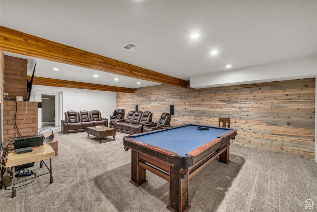 Recreation room with beam ceiling, pool table, wood walls, and light carpet