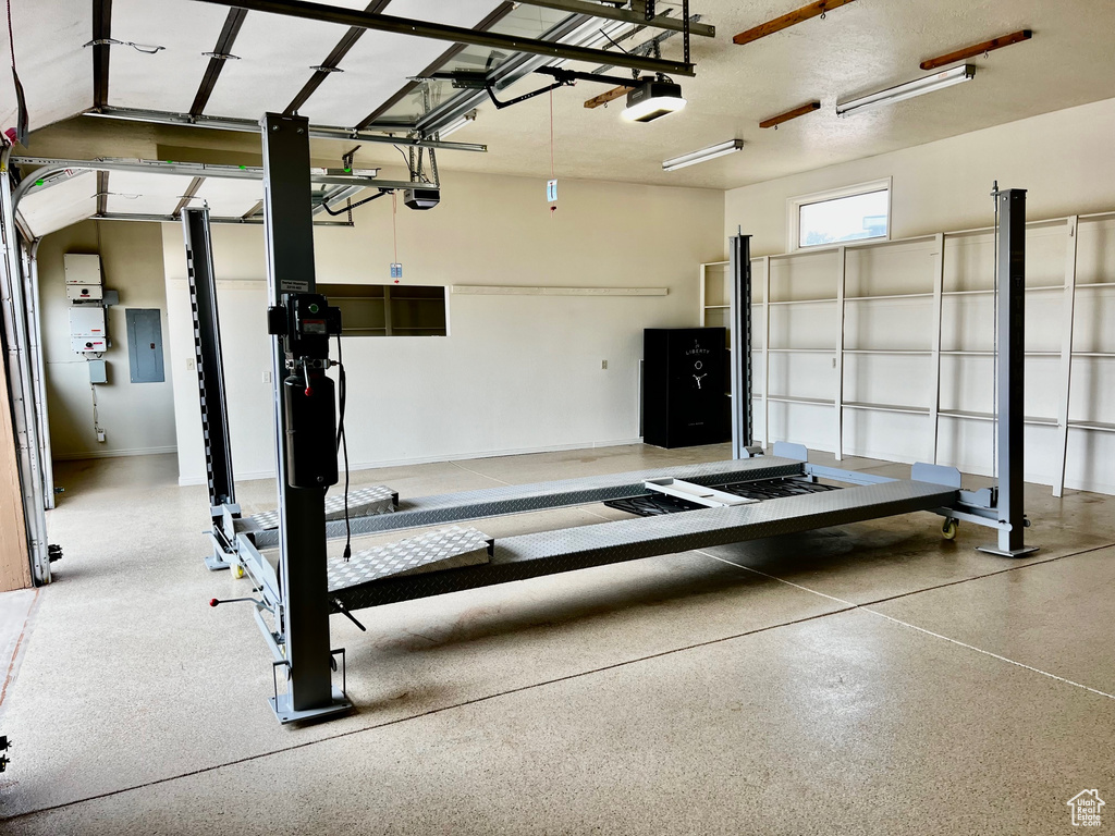 Garage with electric panel and a garage door opener