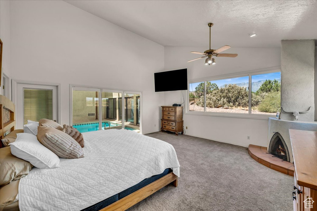 Bedroom featuring high vaulted ceiling, a textured ceiling, access to outside, light carpet, and ceiling fan