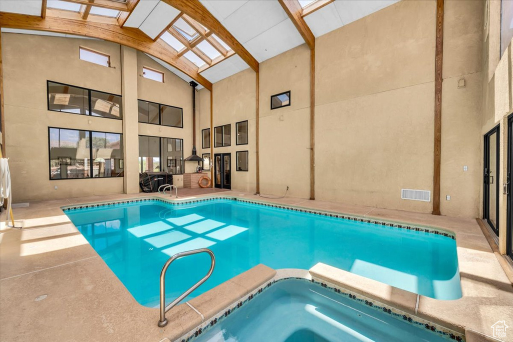 View of pool with an indoor hot tub