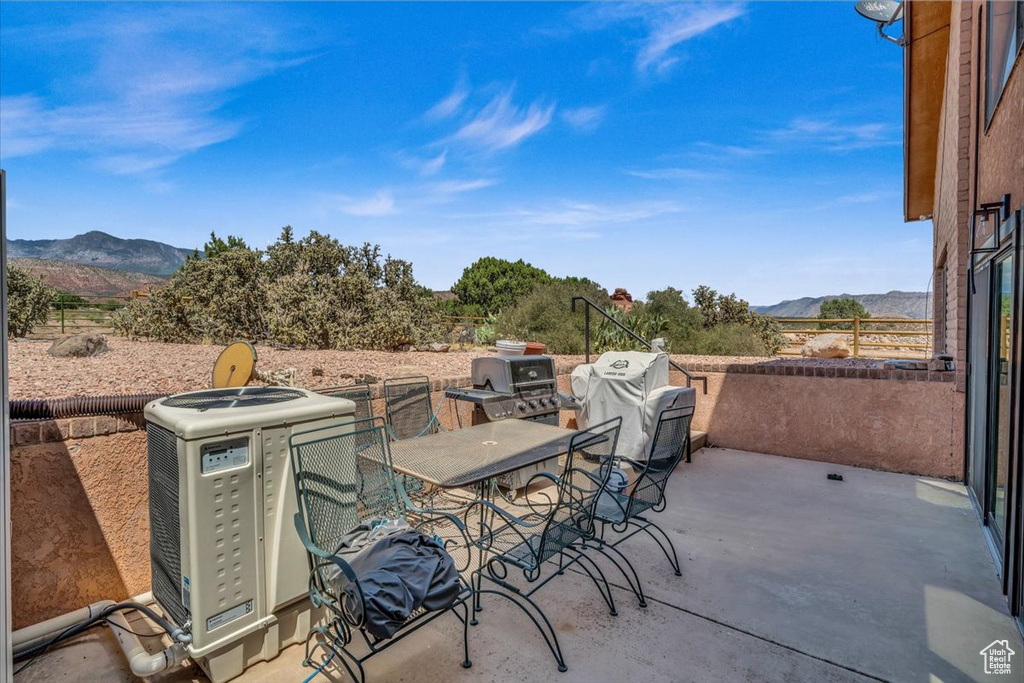 View of patio with central AC unit and a mountain view