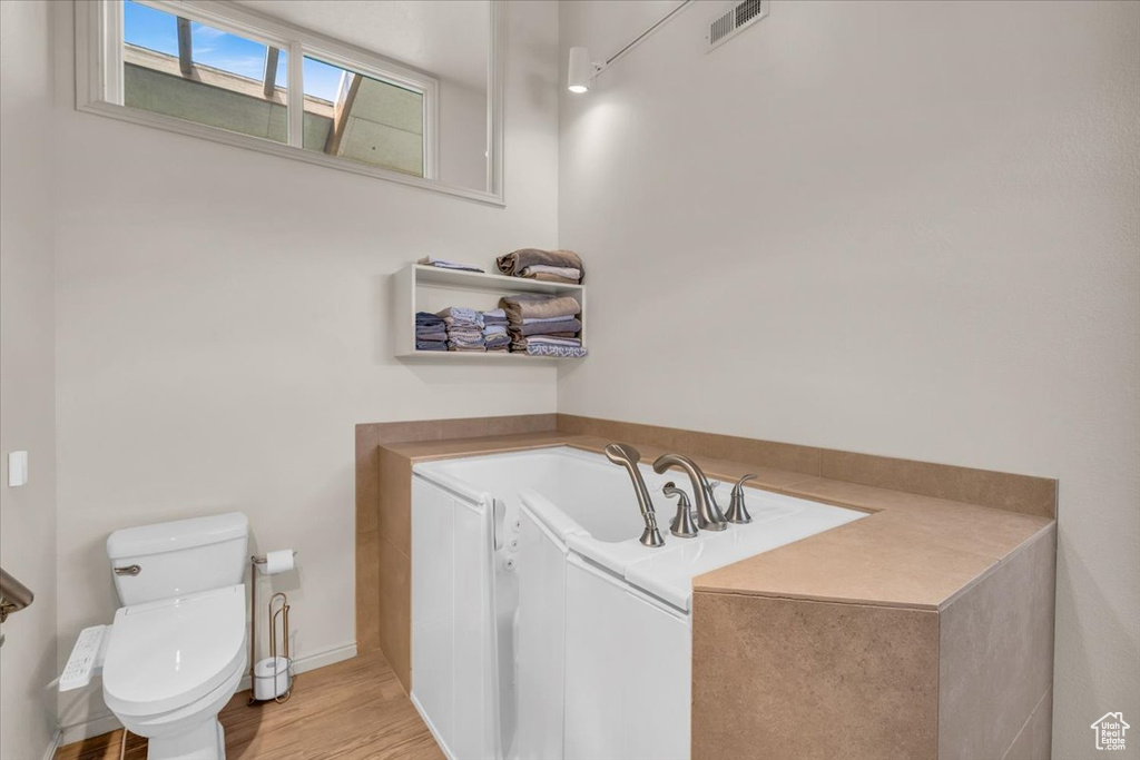 Bathroom featuring toilet and hardwood / wood-style flooring