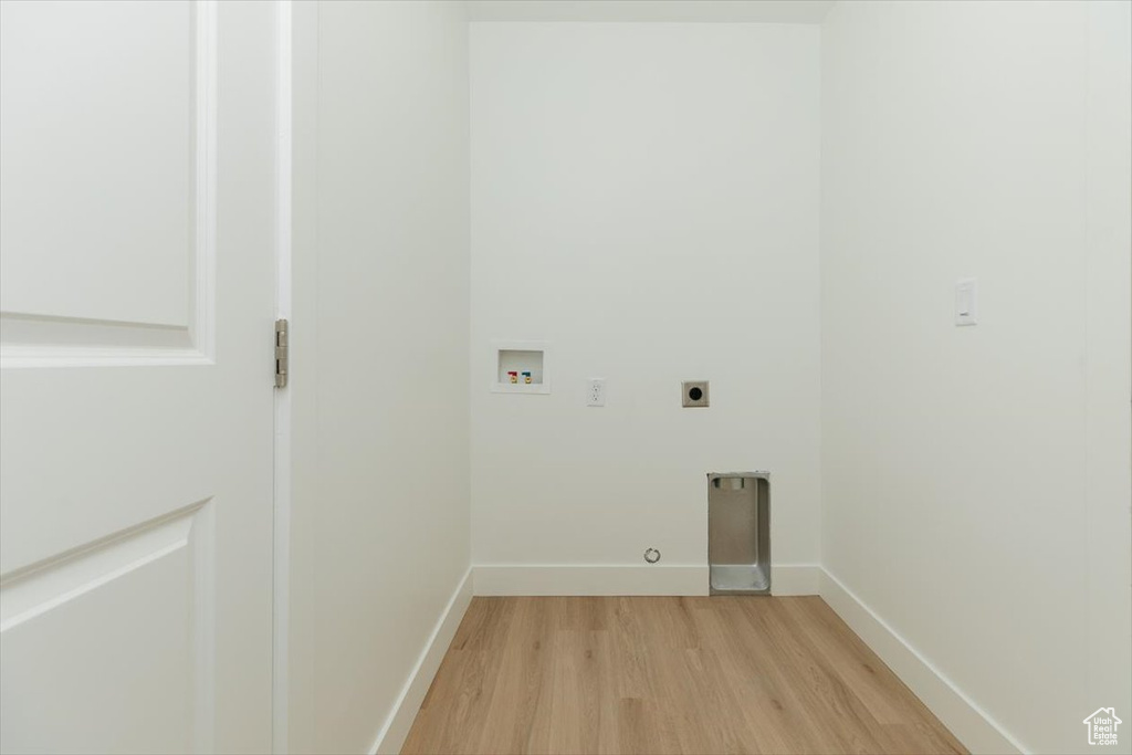 Clothes washing area with washer hookup, electric dryer hookup, and light hardwood / wood-style floors