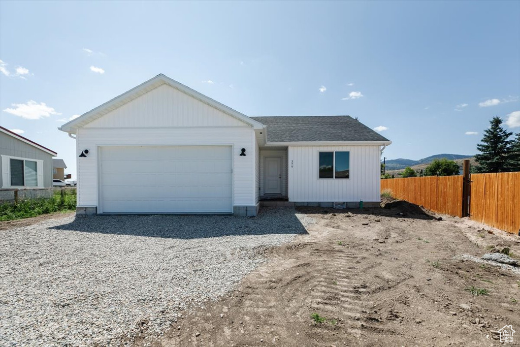 View of front facade featuring a garage