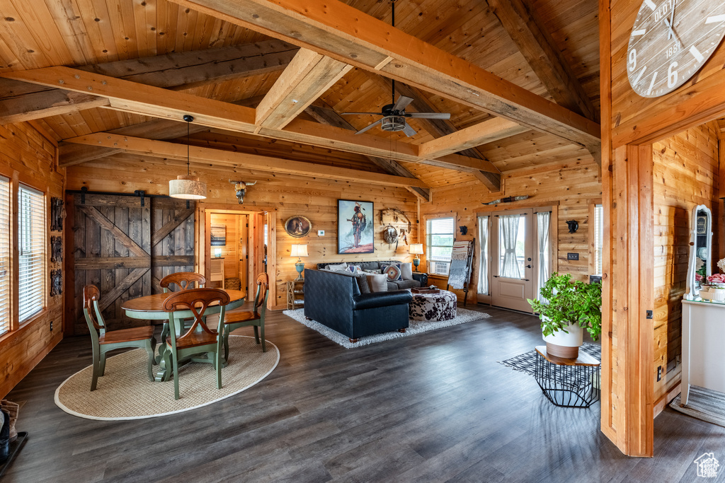 Living room with wood walls, dark hardwood / wood-style floors, and wood ceiling