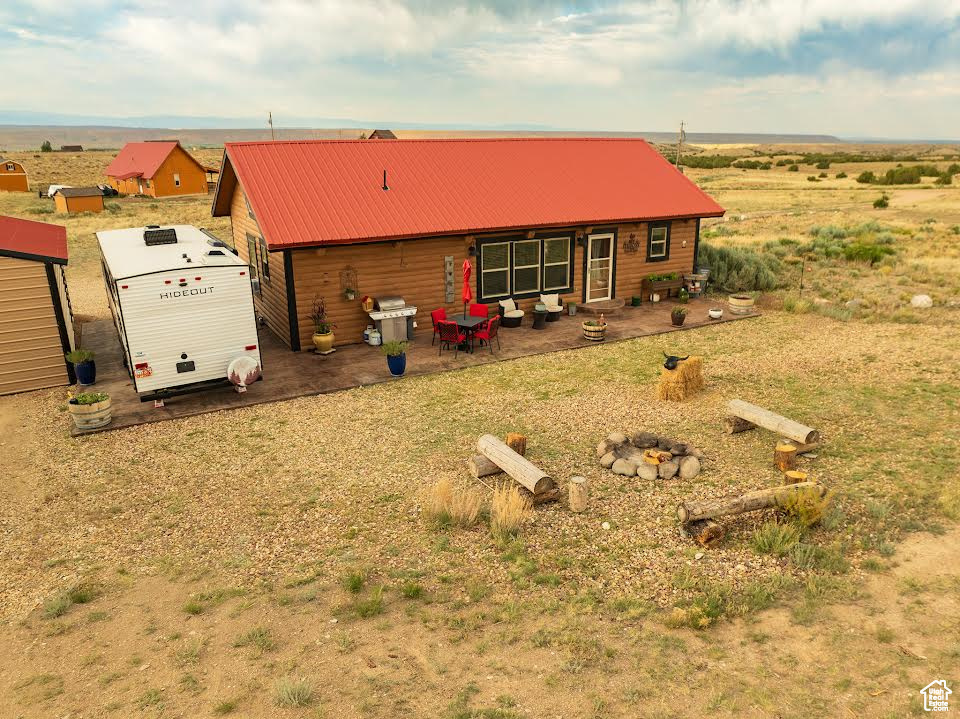 Rear view of house with a rural view and a storage unit