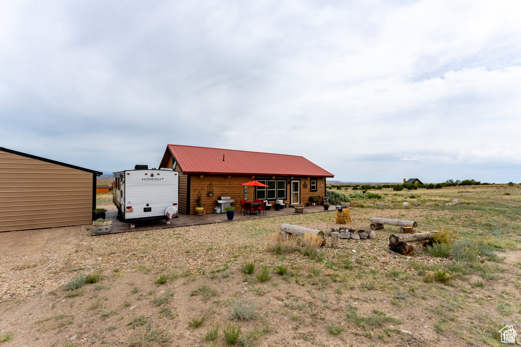 Rear view of property featuring an outbuilding