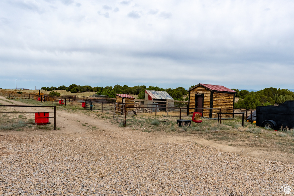 View of playground featuring a rural view and an outbuilding