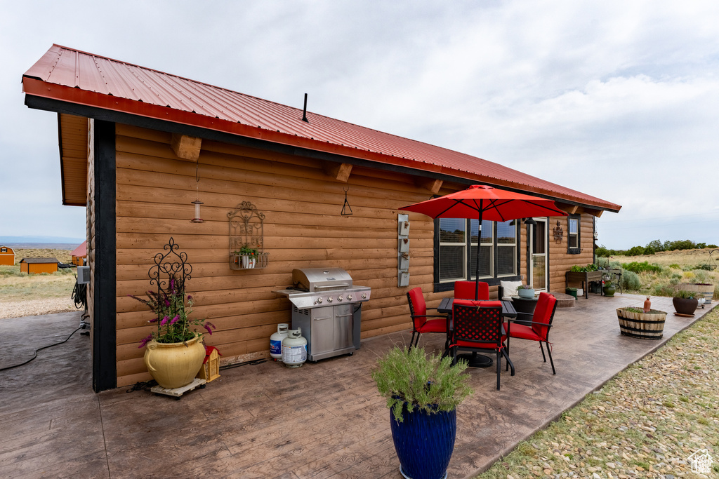 View of patio featuring a grill